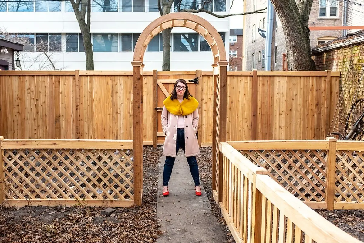 cedar fence with woman standing