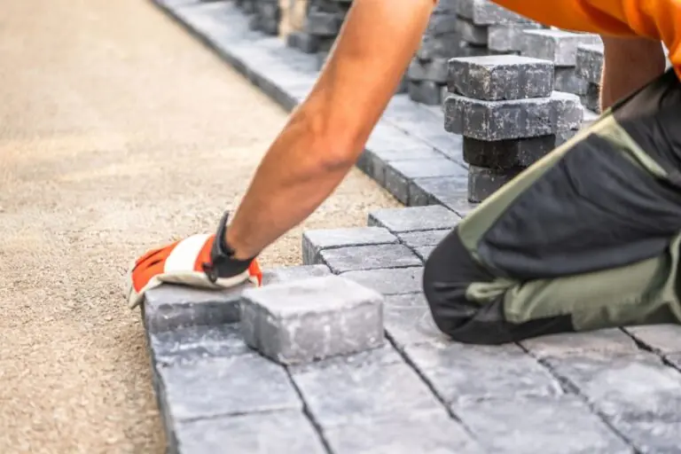 laying paving stones on pathway in bright daylight